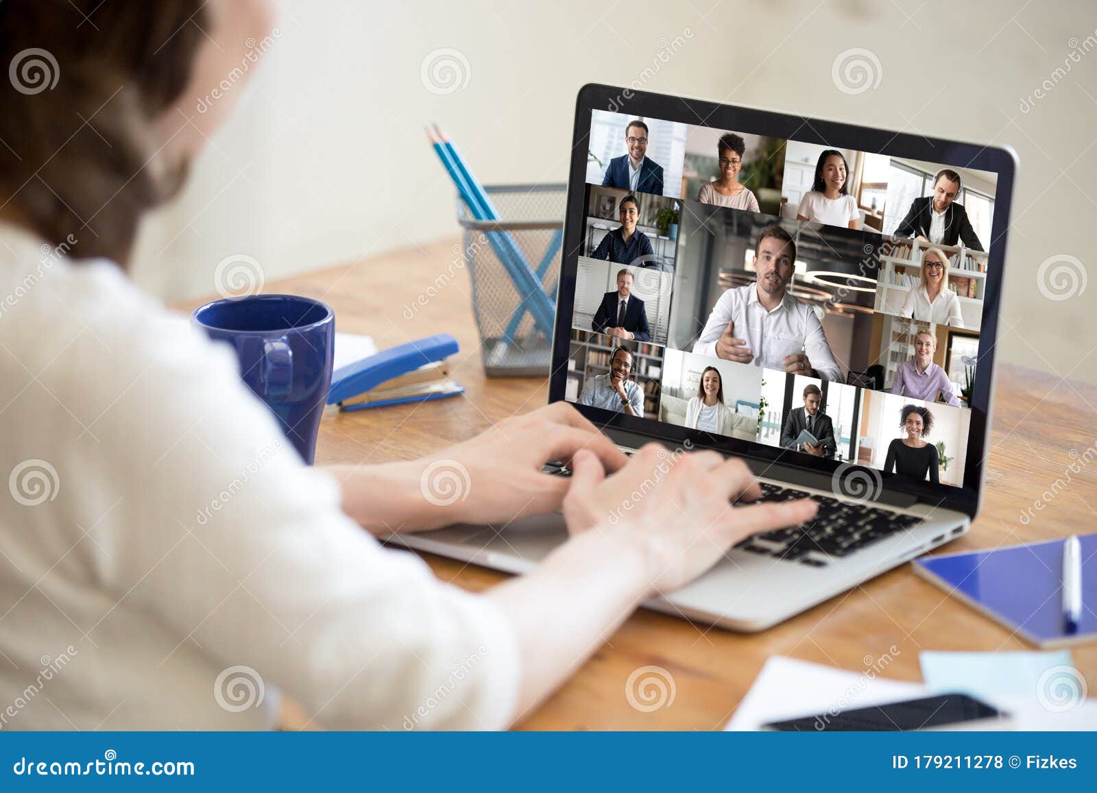 laptop screen view diverse businesspeople involved at group videocall