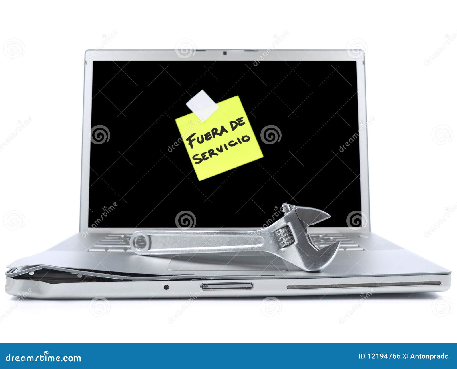 laptop with sticky note and tool