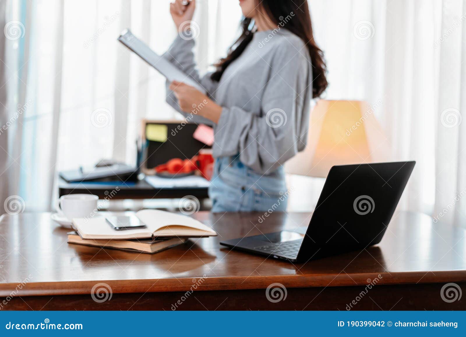 laptop on the table and student hold documant background. student learning at home