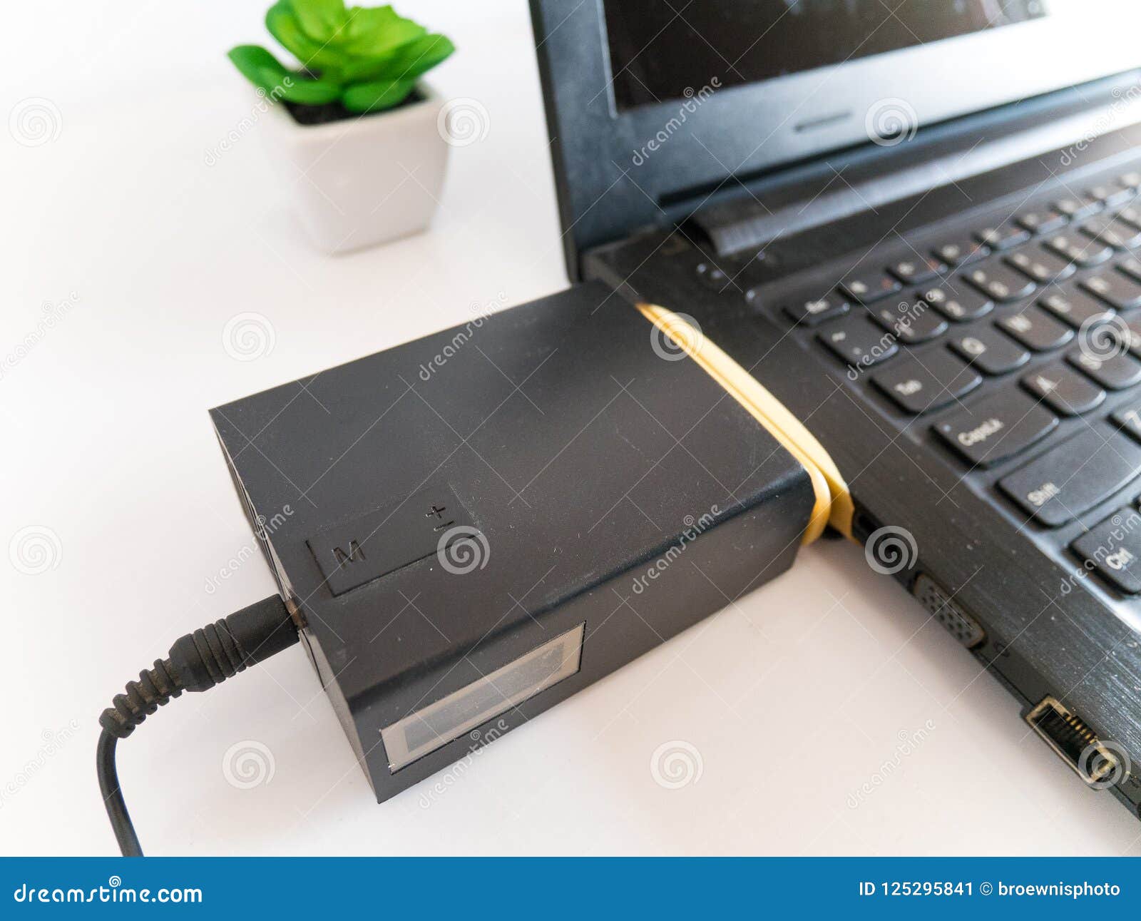 Laptop with Vacuum Cooler Attached To Laptop Air Vent Stock Image