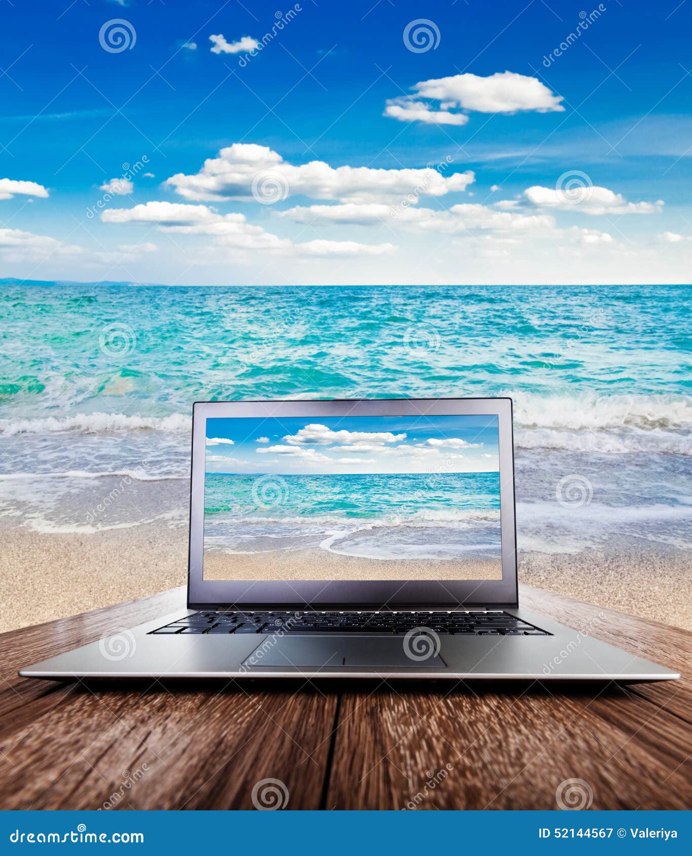 laptop wooden desk view sea over table outdoors sand beach 52144567