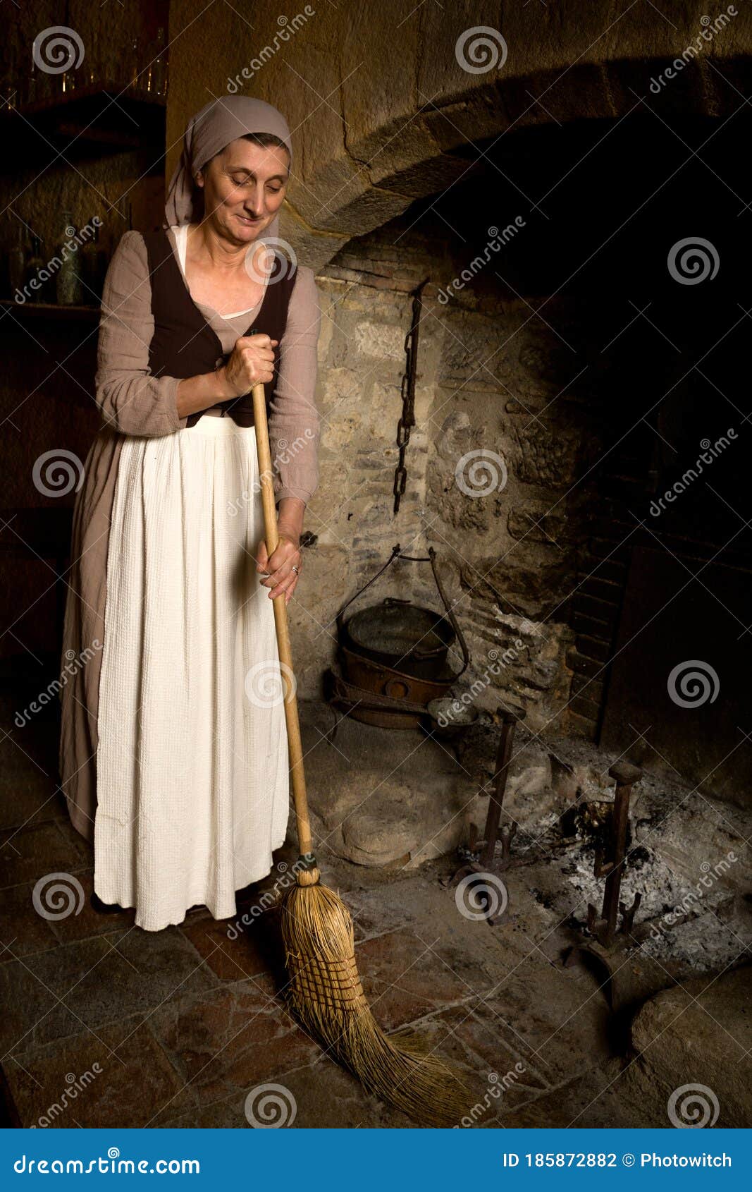 Bruxa bonita com uma vassoura e uma fantasia de empregada