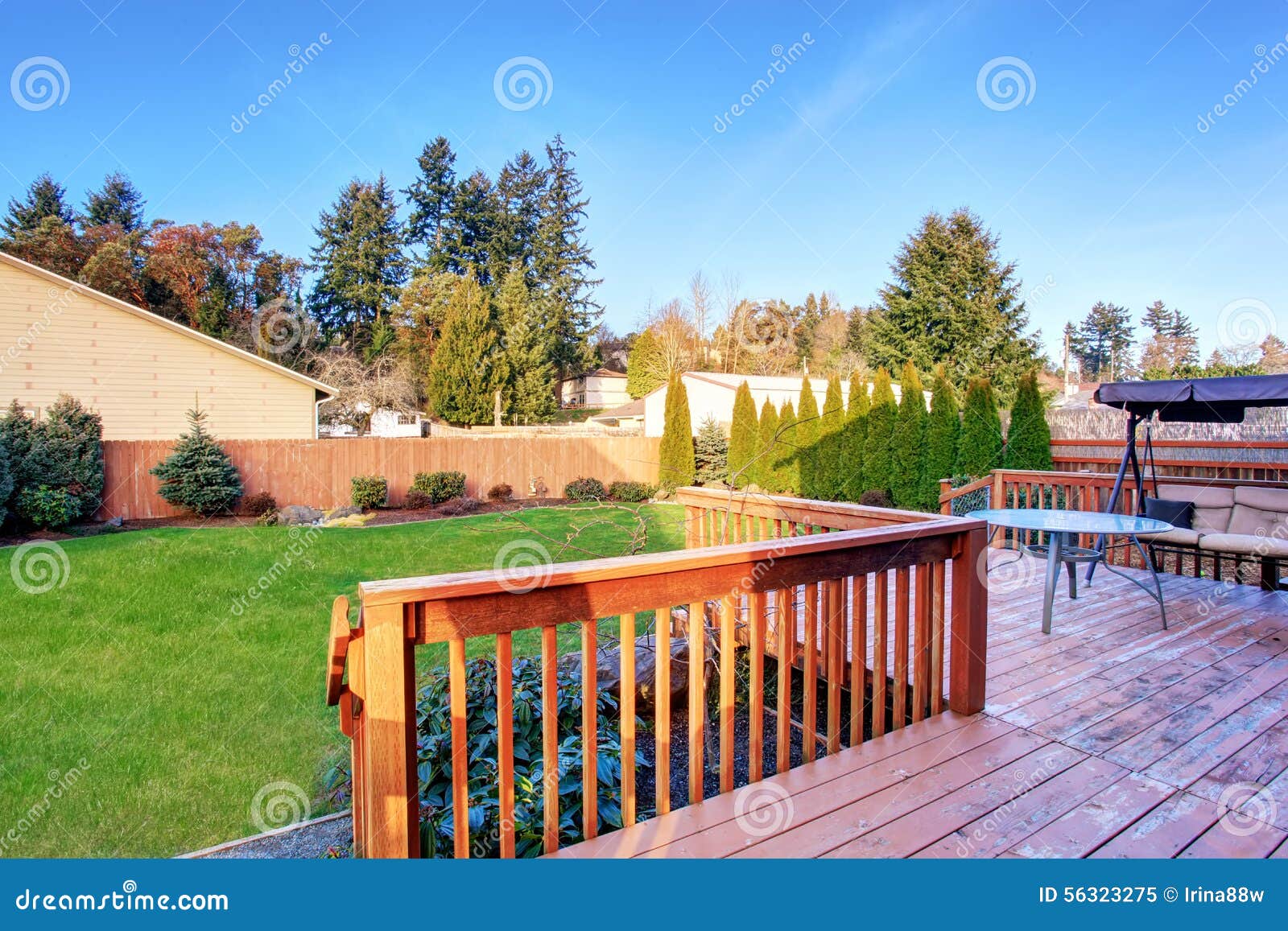 large back yard with lots of grass and deck.