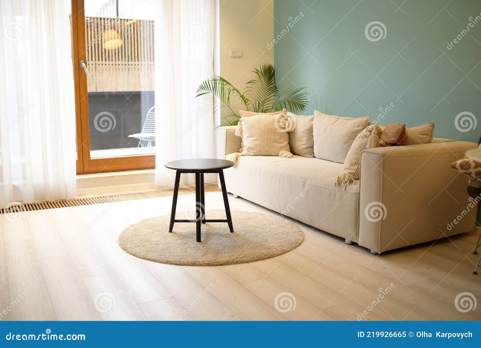 Large Bright Living Room with a Sofa with a Bright Blue Wall. Nice
