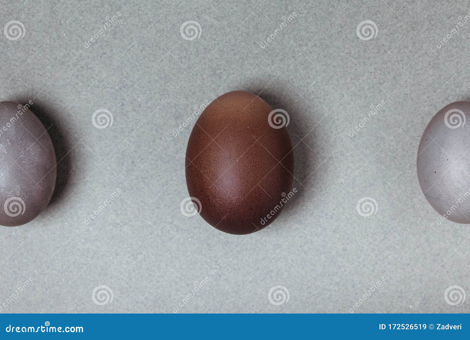 Large Brown Egg between Small Gray. Easter Minimalistic Concept Stock