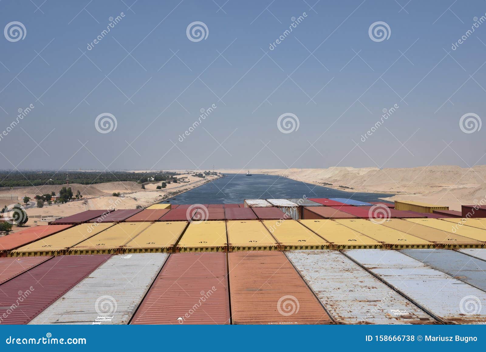 large cargo container ship transiting through the suez canal.