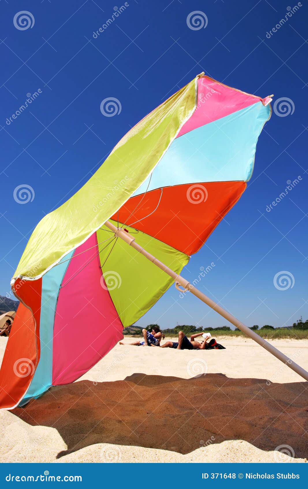 Large Colourful Umbrella on a Sunny Beach in Spain Stock Photo Image