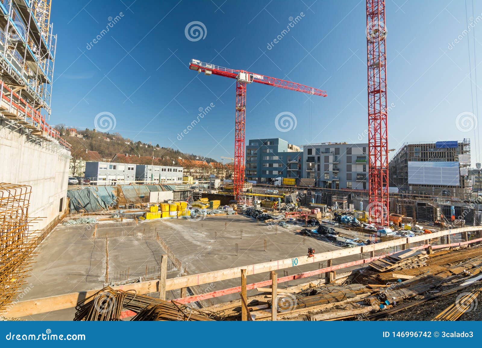 Large Construction Site with Finished Foundation, Cranes and Building