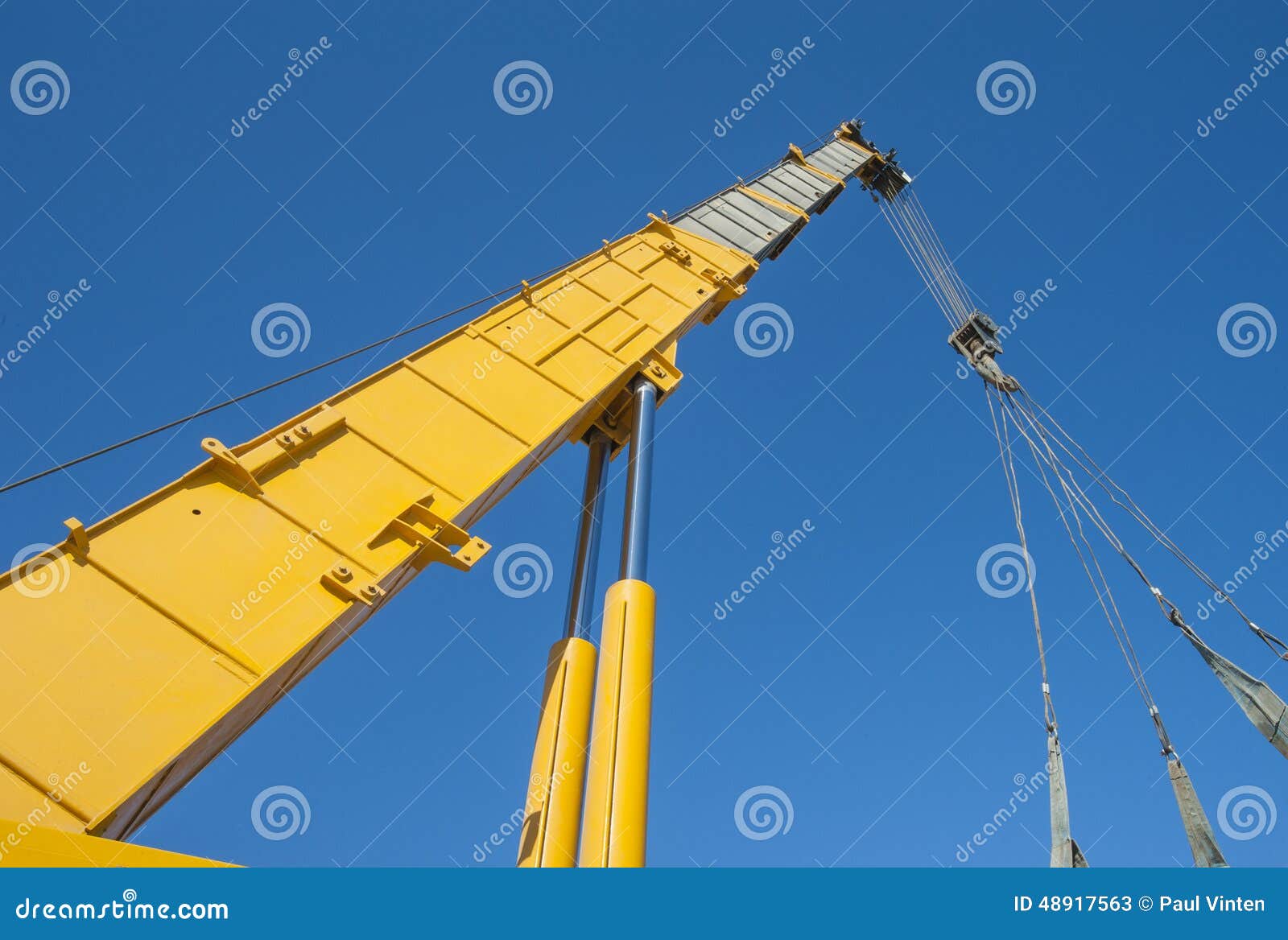 large crane jib against blue sky background