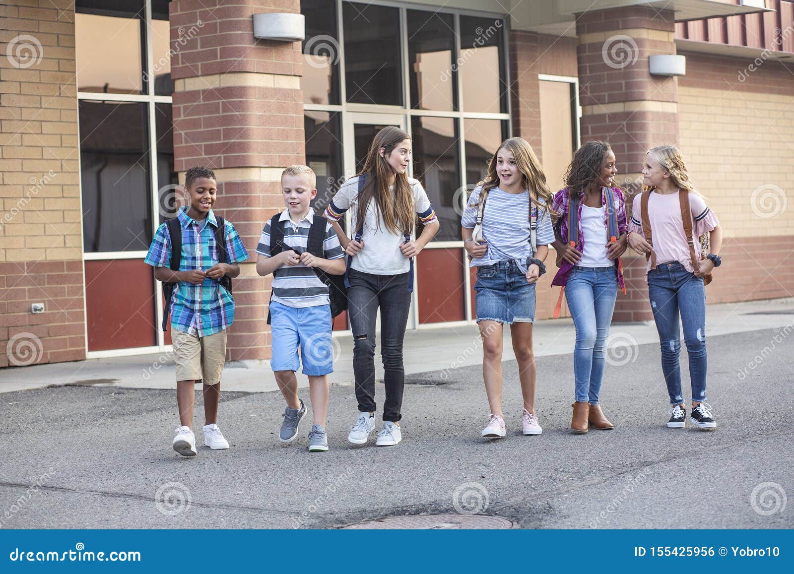 Large, Diverse Group of Kids Leaving School at the End of the Day ...