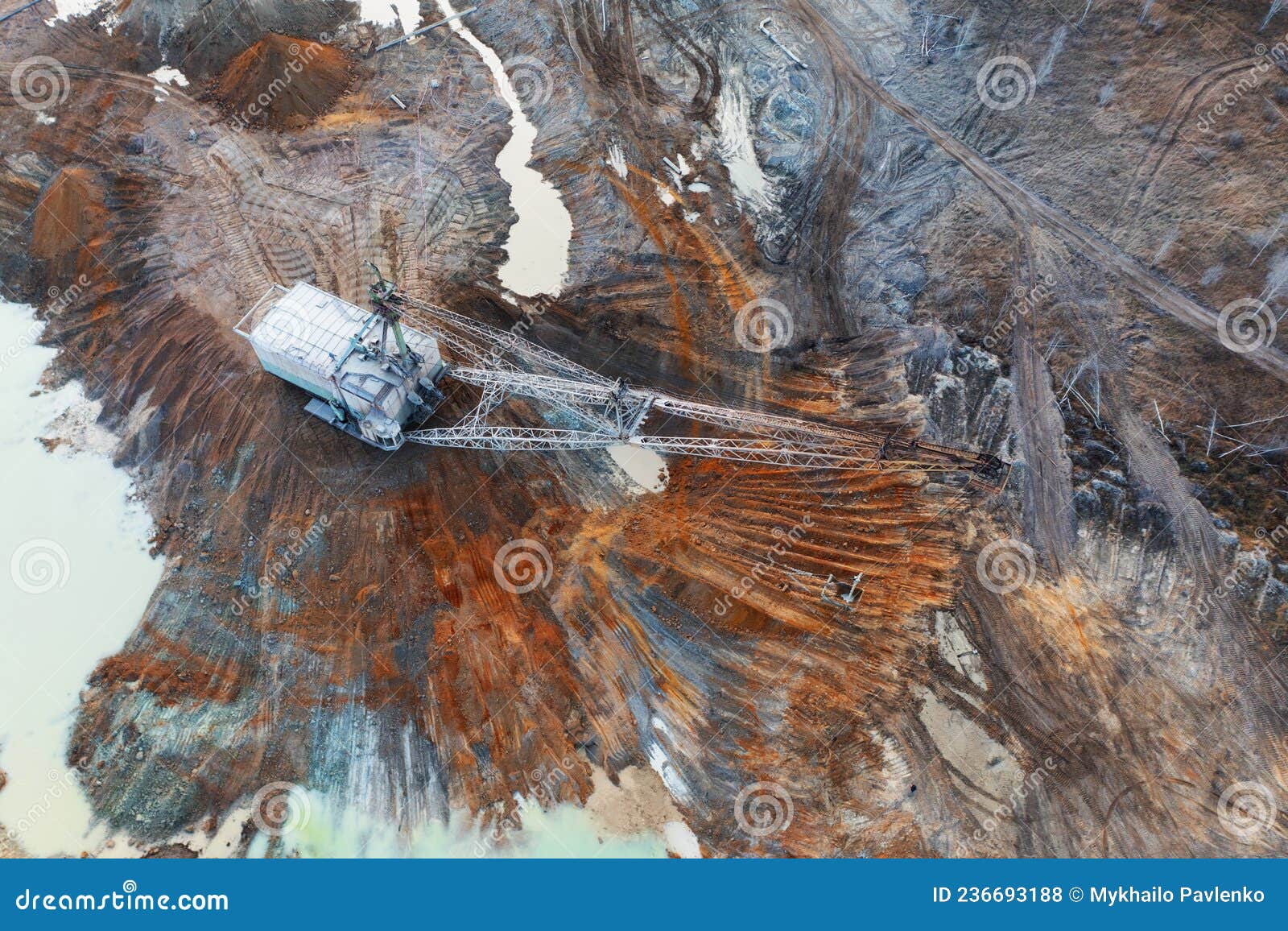 a large excavator works in the quarry. drone view.