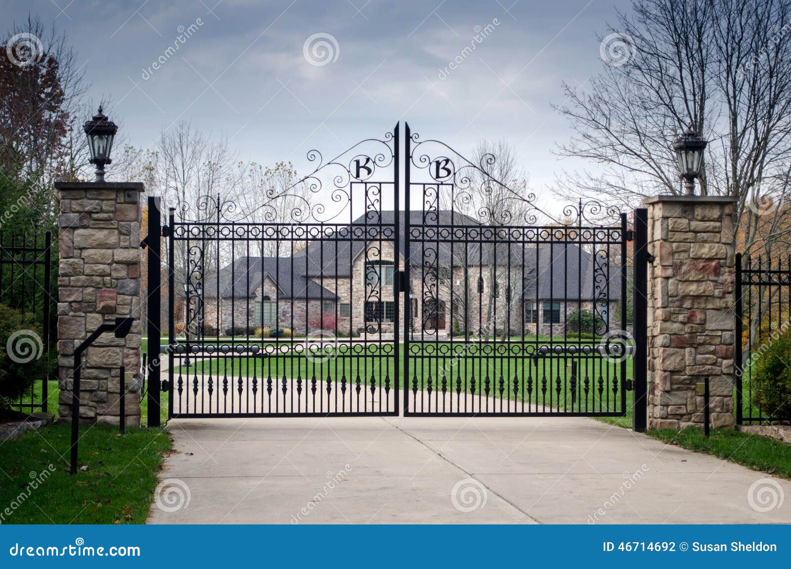 large fancy mansion behind a gated entry