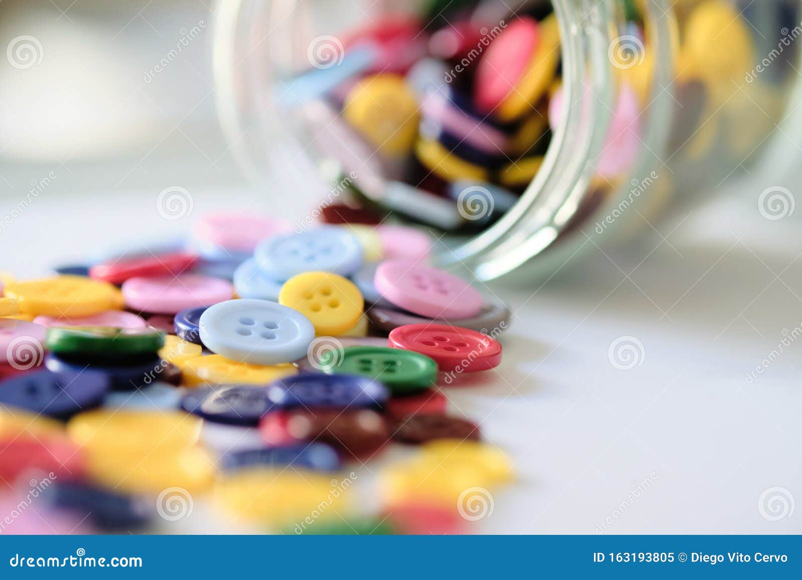 Large Group of Colorful Plastic Sewing Buttons on Table Stock Image