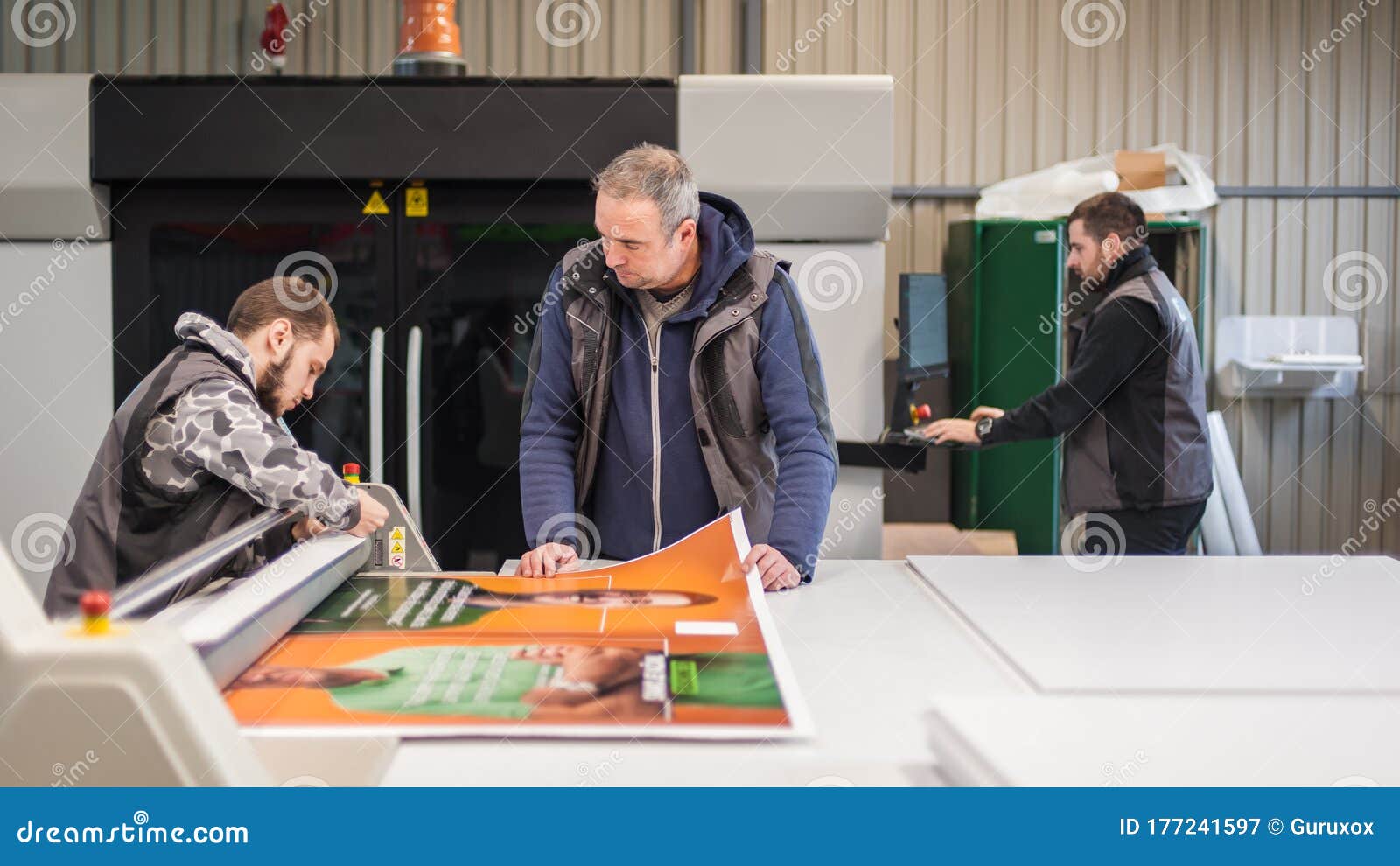 Large Group of Technicians Works in Printing Press Hall Stock