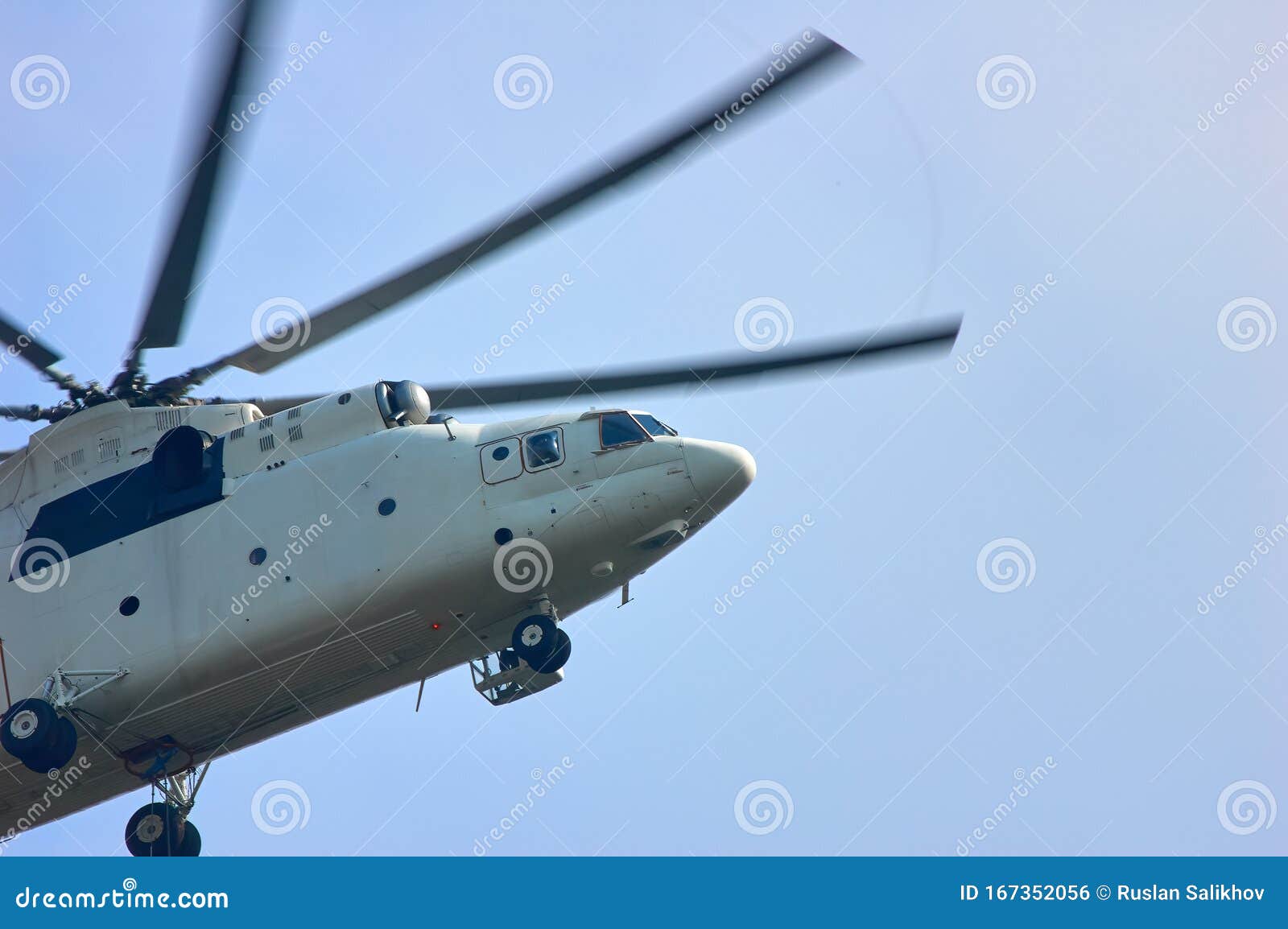 A Large Helicopter is Flying in the Blue Sky, Bottom Side View Stock