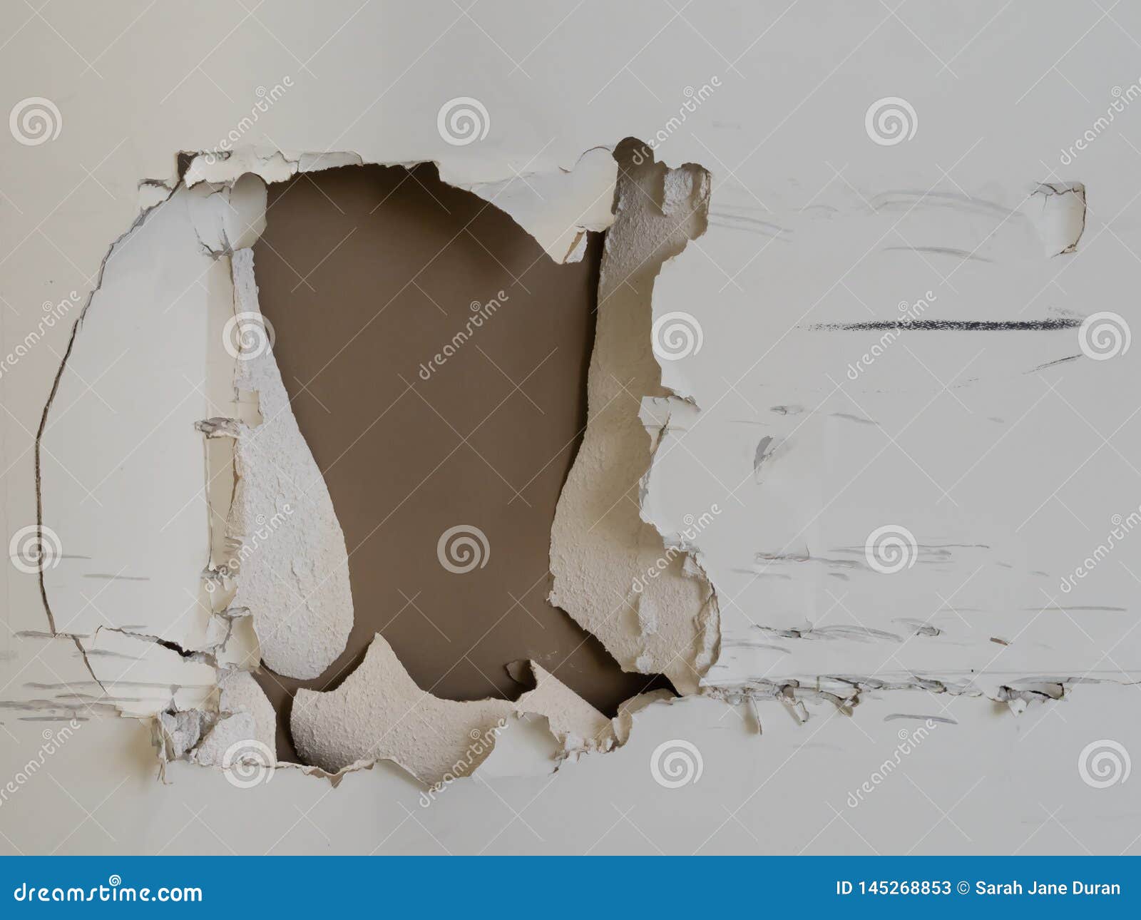 Large Hole with Skid Marks and Cracks in Drywall of a Cream Wall Stock ...