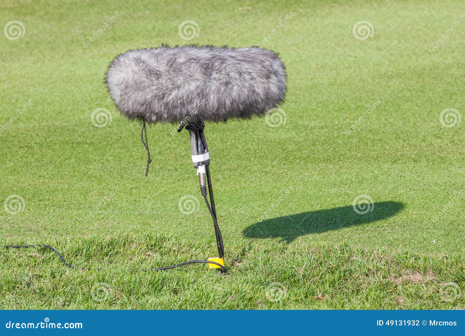 A Large Microphone Boom with Windshield Situated in Golf Tournament for Live Broadcasting