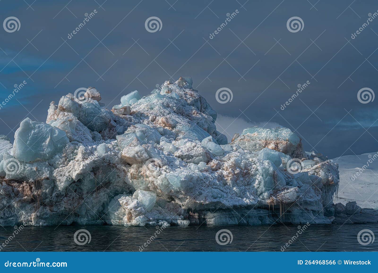 Large Multicolored Ice Chunk Floating on the Arctic Ocean Under a Moody Large Multicolored Ice Chunk Floating on the Arctic Ocean Under a Moody