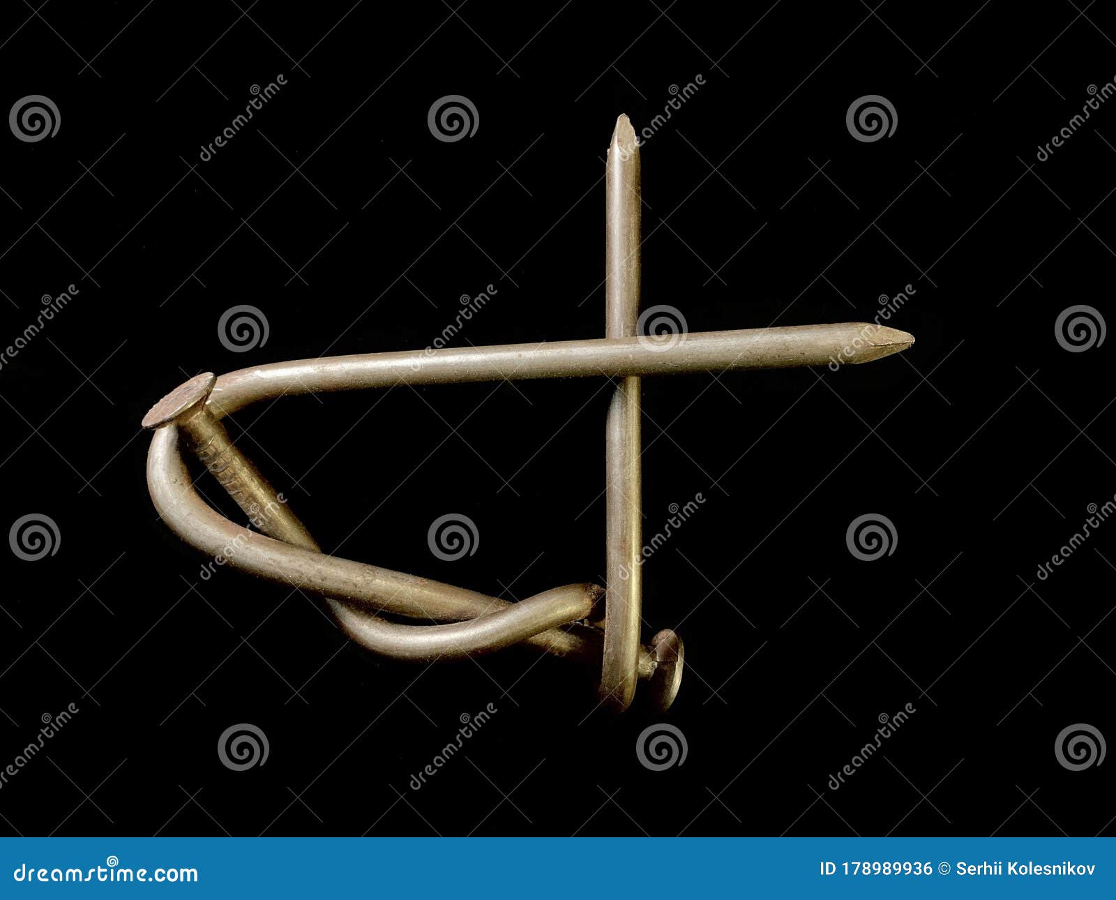 A Large Nail is Twisted into a Knot. Bent, Metal Nails on a Black ...