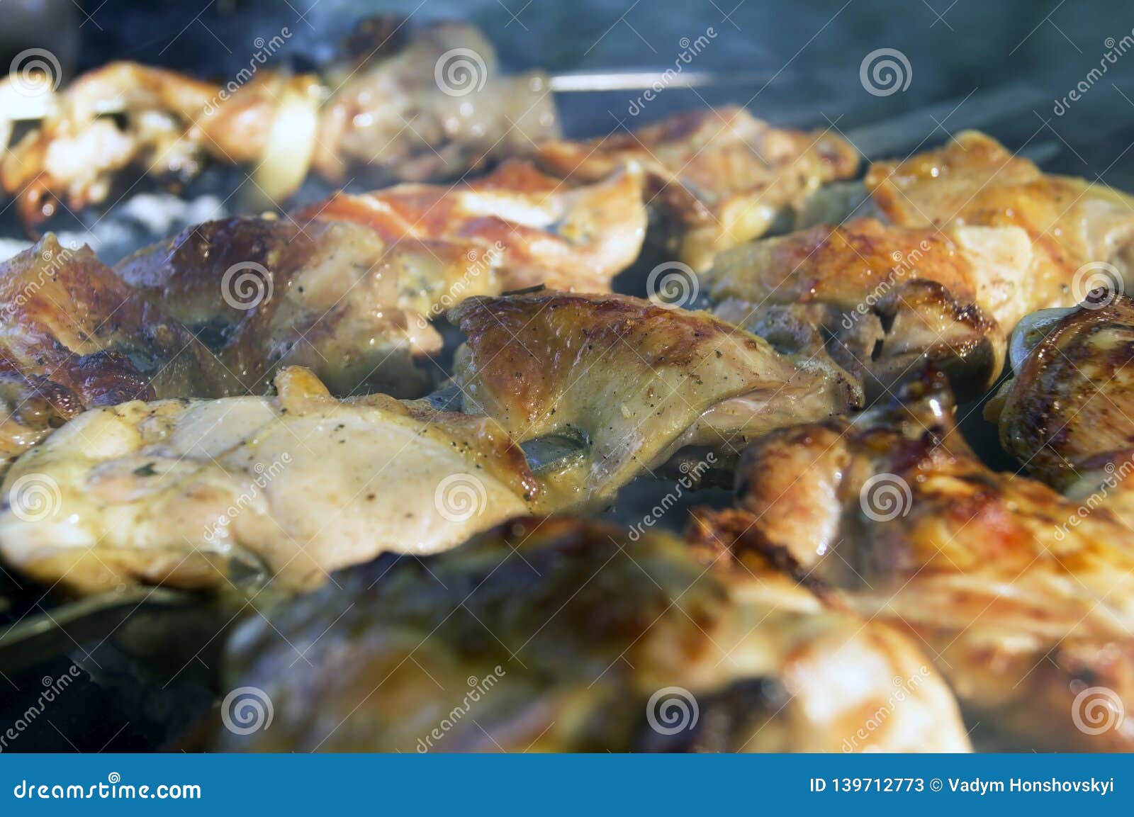 Large Pieces of Chicken Meat in a Smoke on the Grill Stock Image
