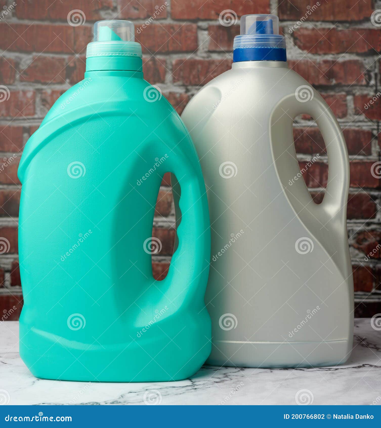 Large Plastic Bottles with Liquid Detergent on a Brown Brick Wall