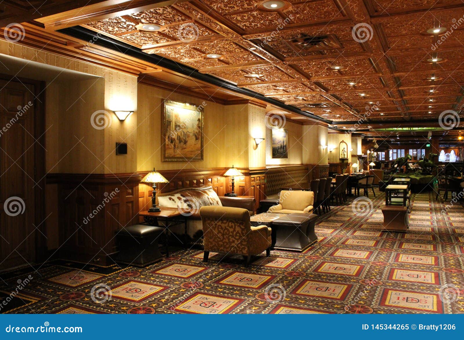 Spacious Room With Metal Ceilings Comfy Chairs And Soft