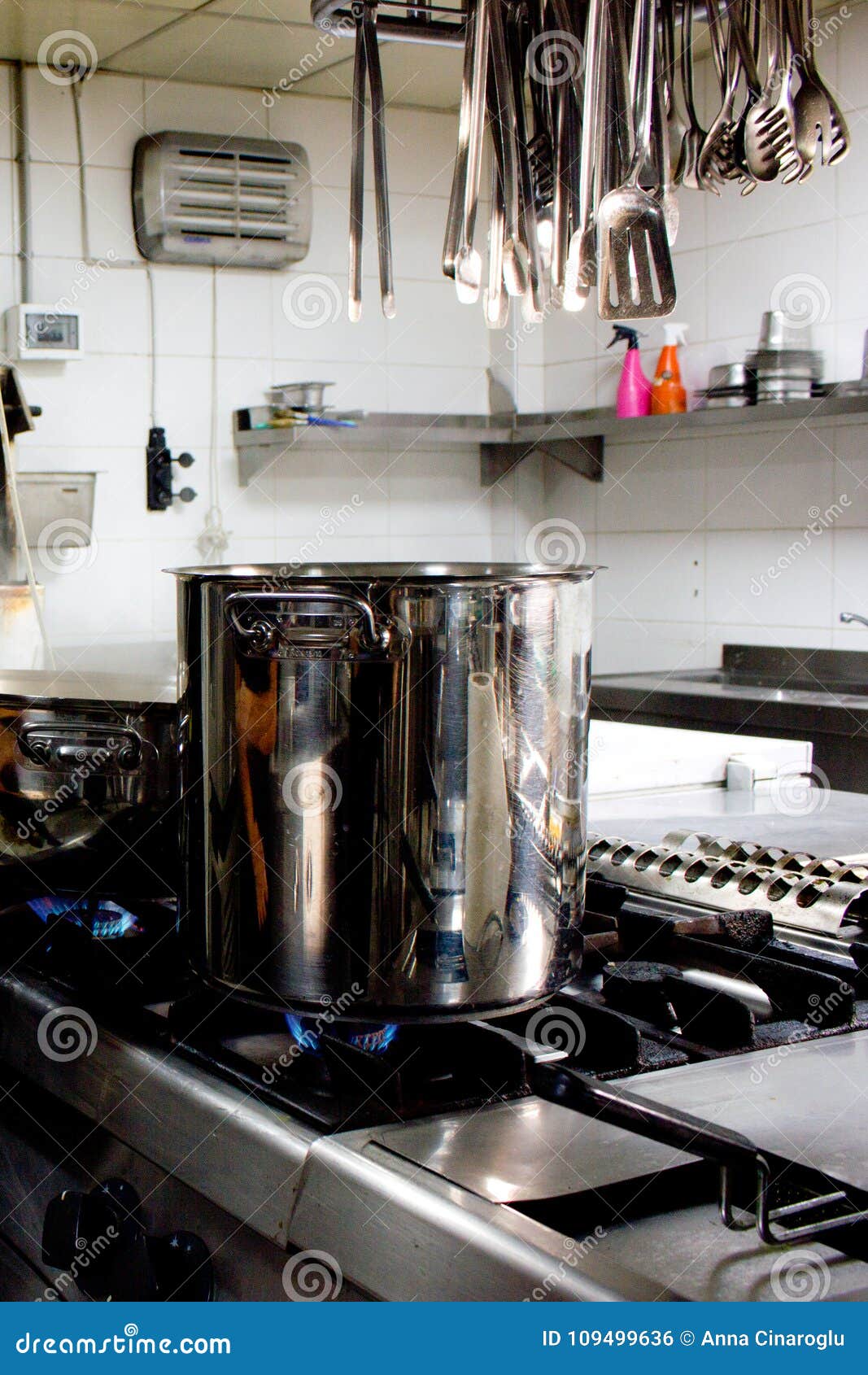 Large Steel Professional Pan on the Stove with Fire in the Restaurant Kitchen Stock Photo