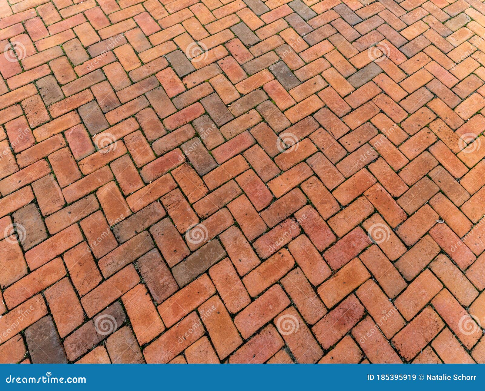 large tall background of grunge brick pavers laid in herringbone pattern, receding perspective backdrop for construction