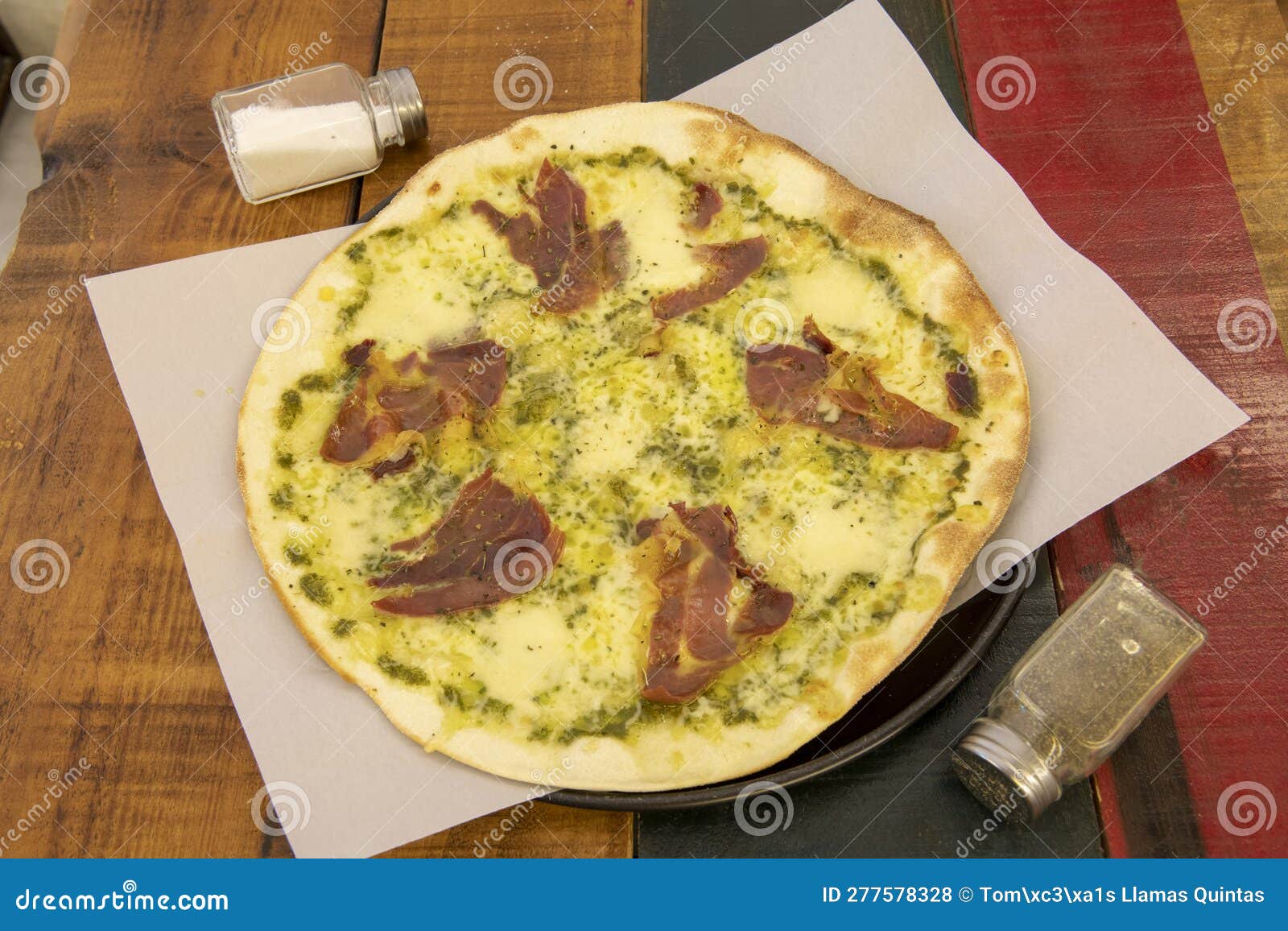 Large Thin Crust Pizza with Prosciutto, Pesto Sauce Stock Photo Image