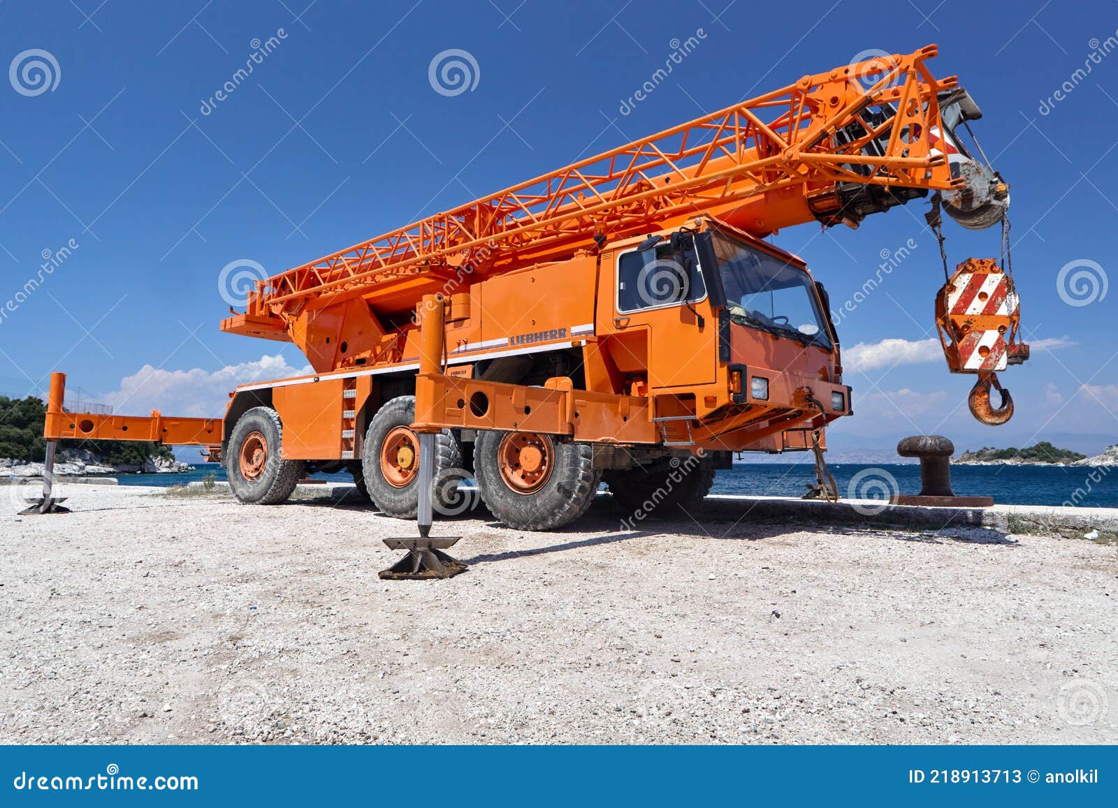 A Large Truck Crane Stands in the Port Awaiting Loading and Unloading