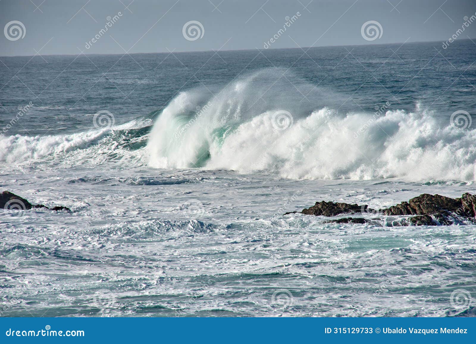 large waves breaking at the baiona breakwater, pontevedra, spain