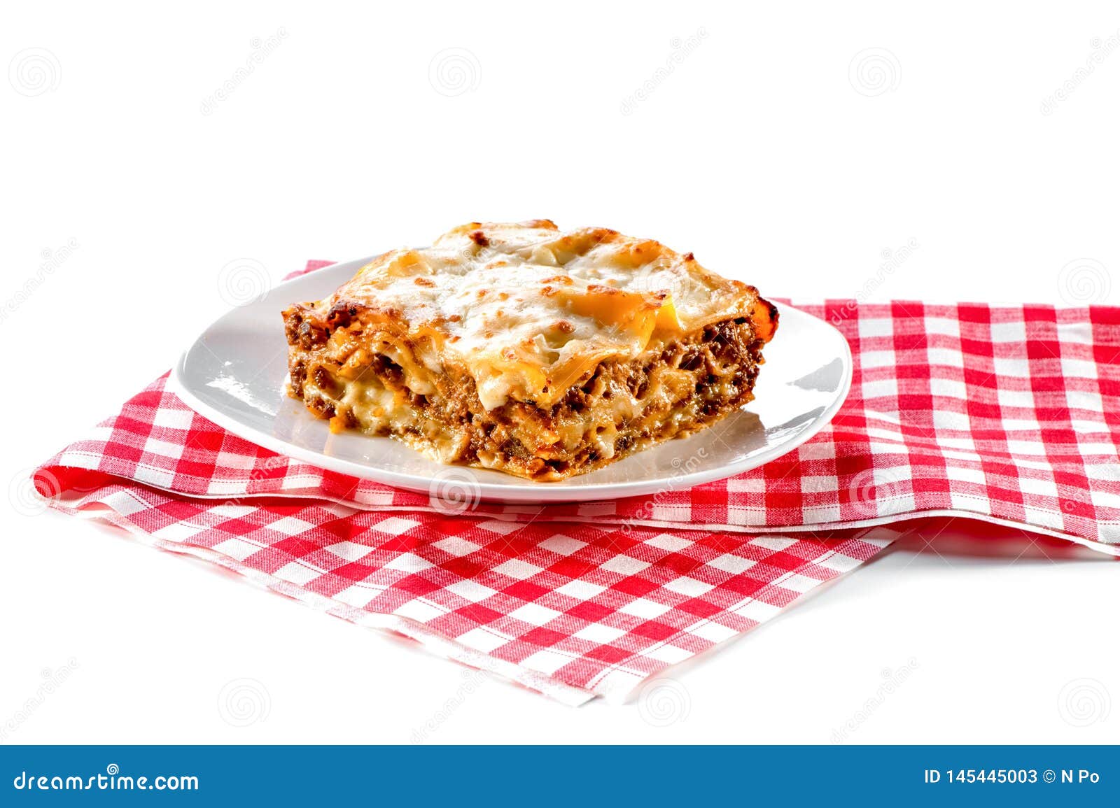 Lasagna with Plate and Checkered Red Napkin Isolated on White ...