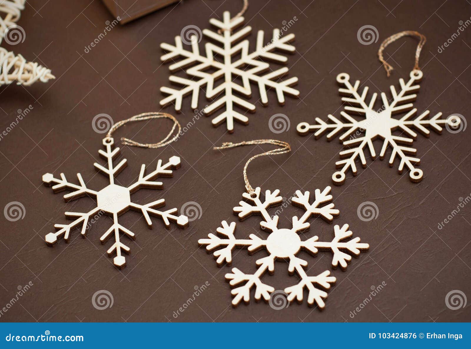 Laser Cut Wood Snowflakes Ornaments. Wooden Snowflakes on Brown Background.  Christmas Holliday Concept. Stock Photo - Image of ornament, design:  103424876