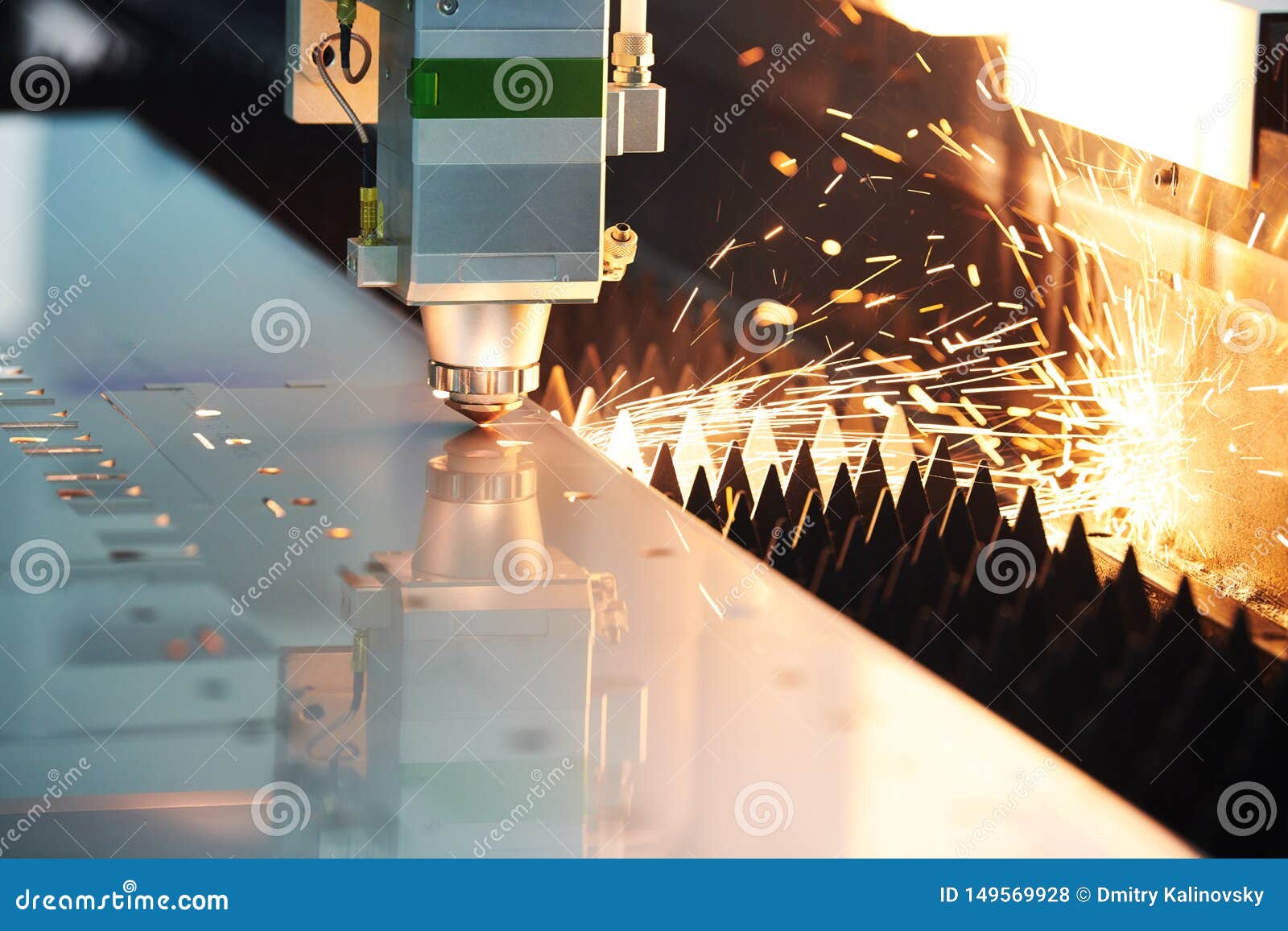 laser cutting. metal machining with sparks on cnc laser engraving maching