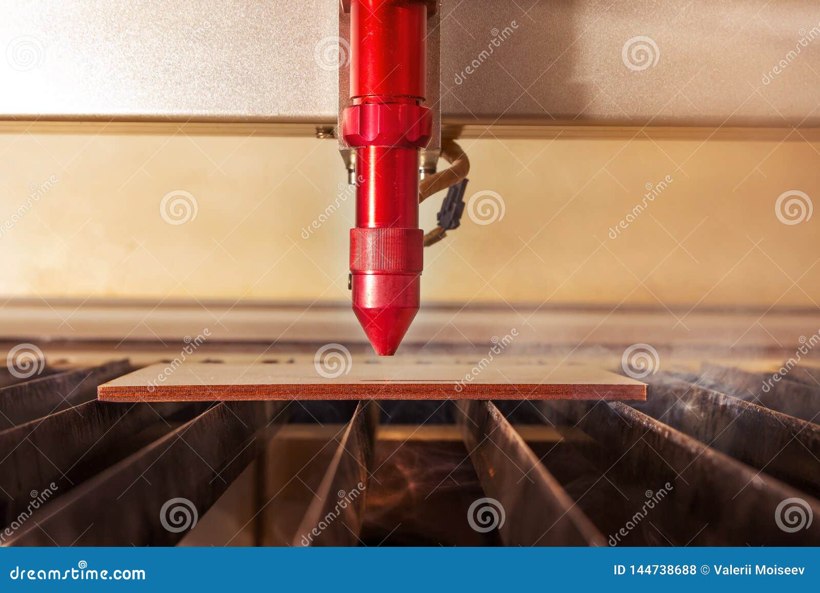 Laser Engraver Working and Engraving Flat Wooden Board Stock Photo