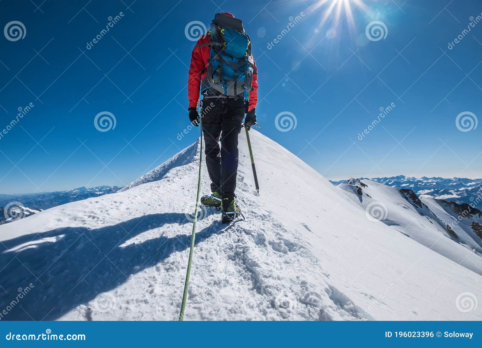 last steps before mont blanc monte bianco summit 4,808 m of man with climbing axe dressed mountaineering clothes, boots with