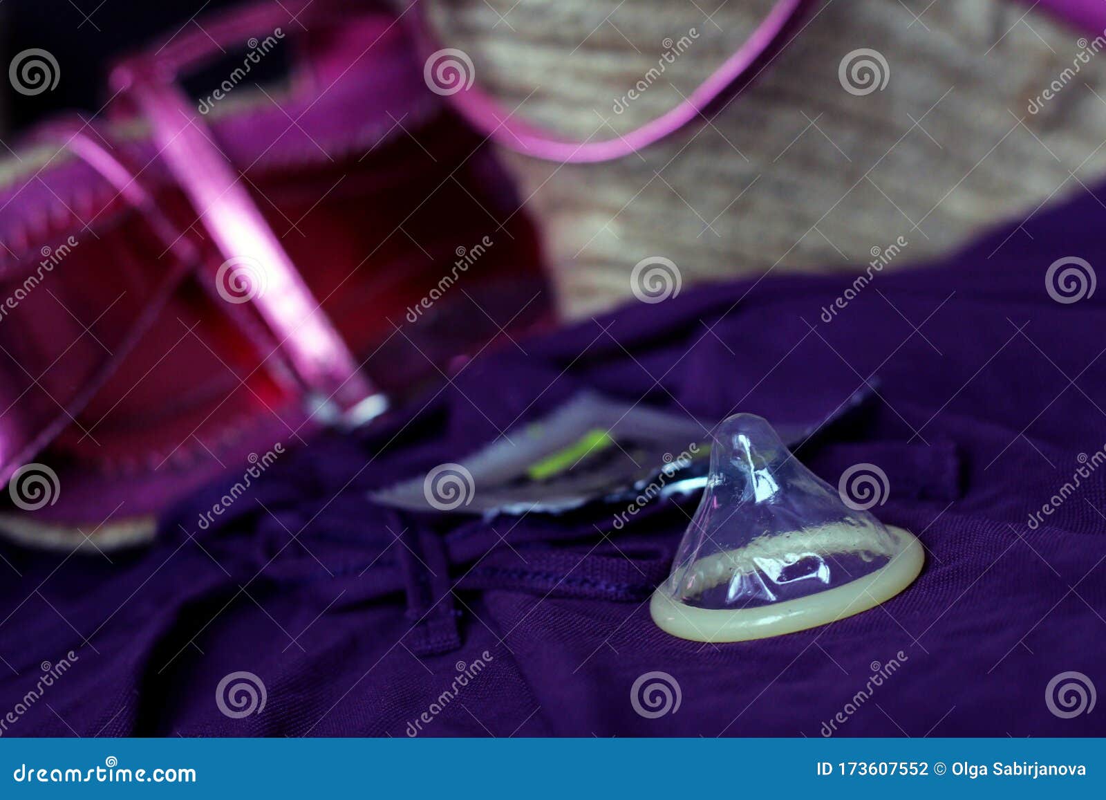 Latex Condom And Womens Things On The Sofa Stock Photo