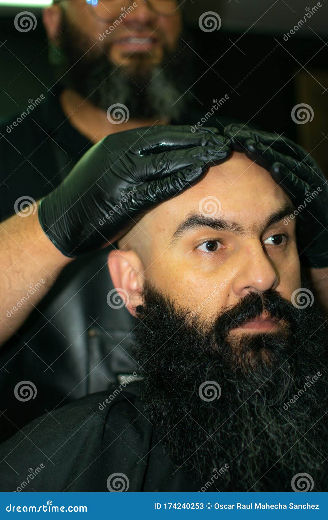 latin american barber working the style with a long beard in the city of bogot