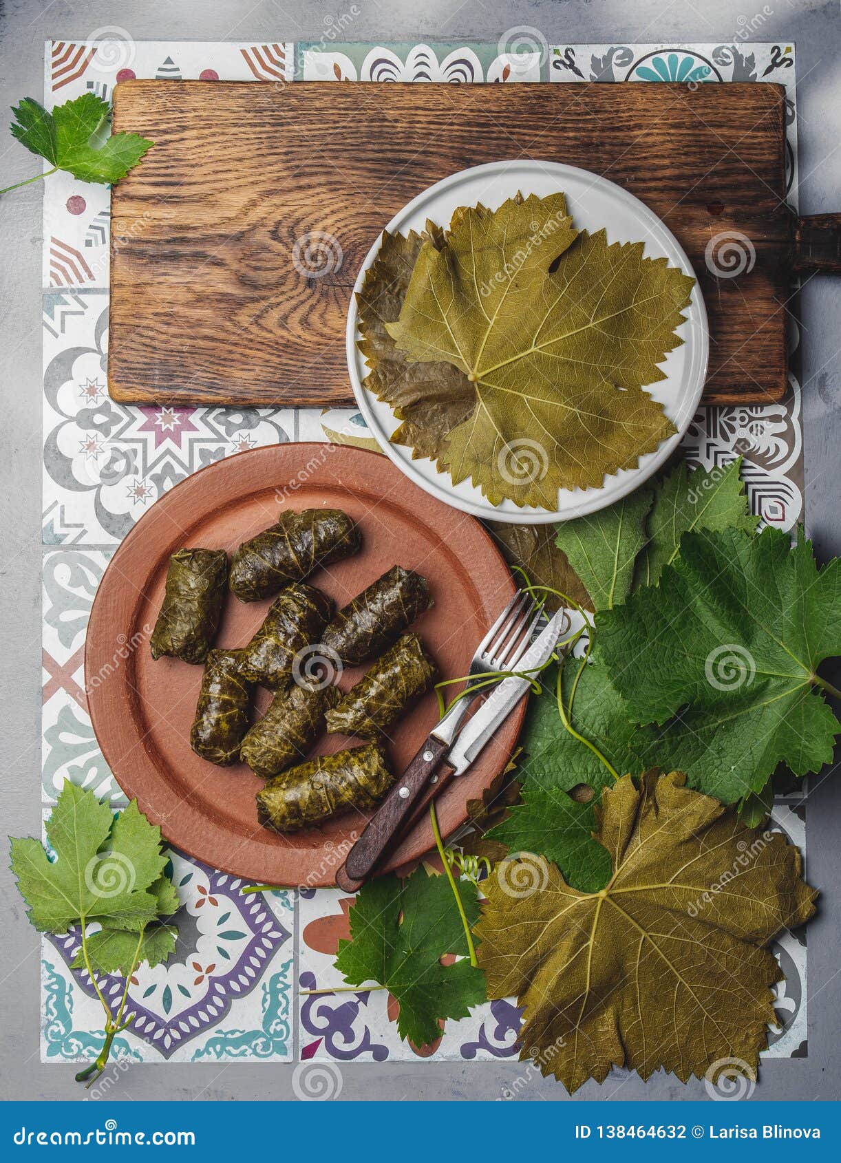 latin american mexican chilean cuisine. ninos envueltos. grape leaves stuffed wish meat on clay plate