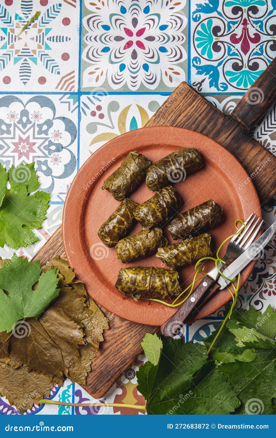 latin american mexican chilean cuisine. ninos envueltos. grape leaves stuffed wish meat on clay plate