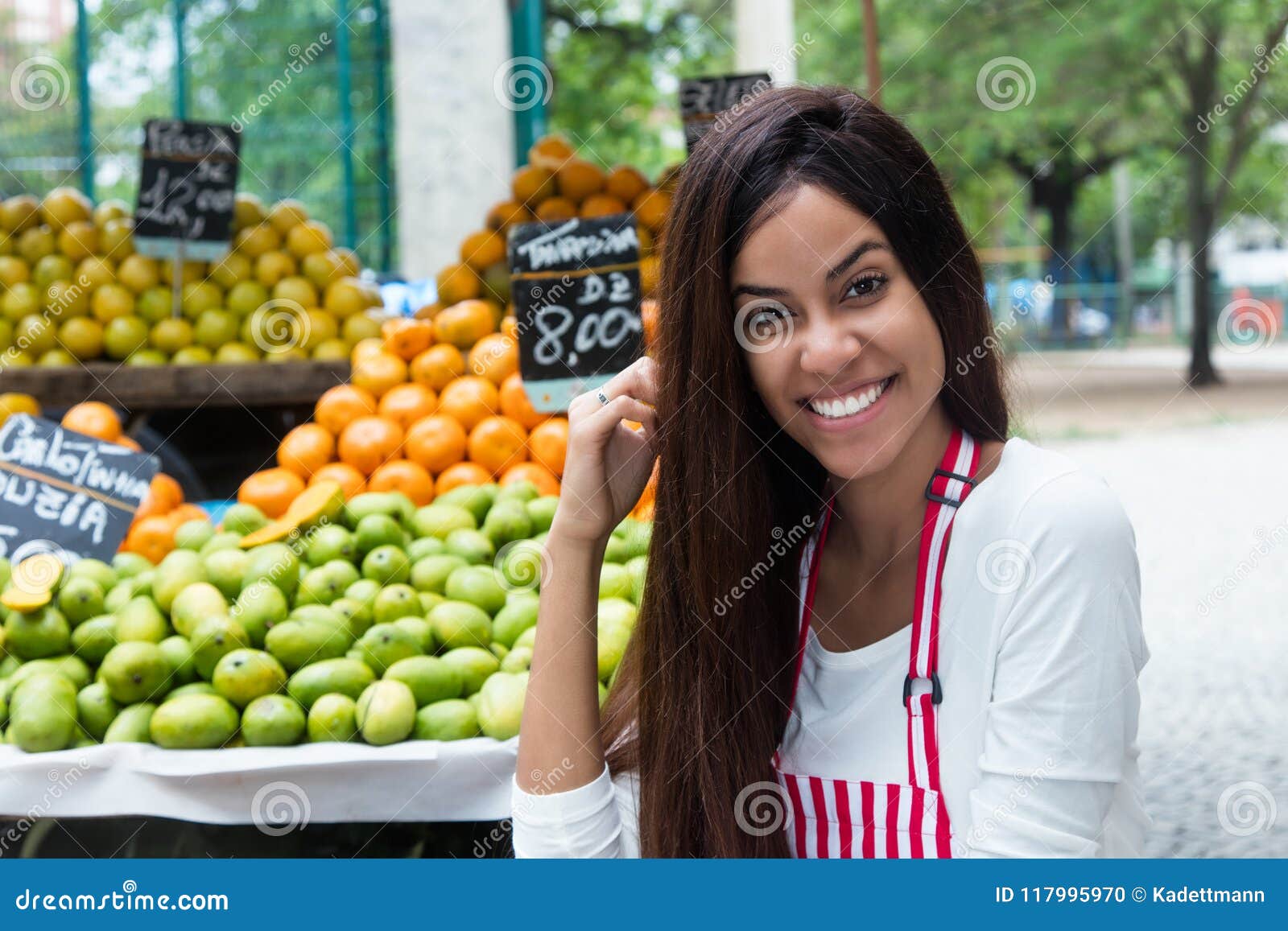 latin american woman selling fruits at farmers market