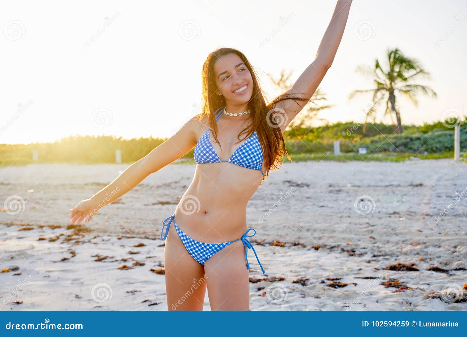 Candid Latinas laying on the beach