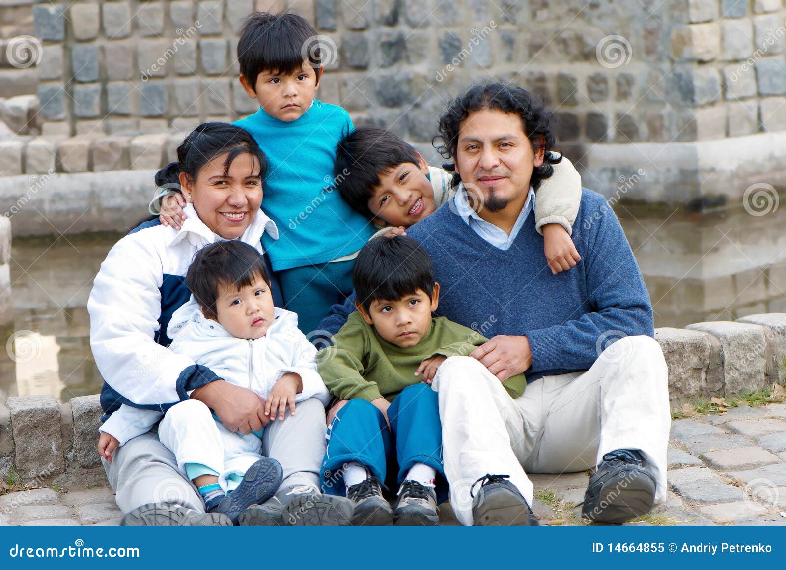 latin family sitting in the street