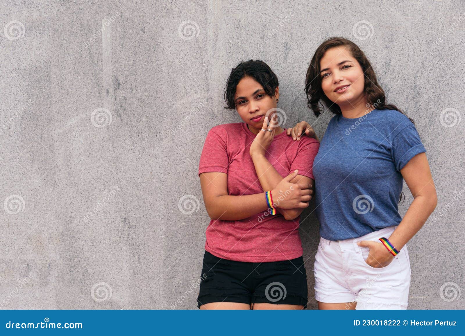 Latin Lesbian Couple Standing On A City Street While Enjoying A Day