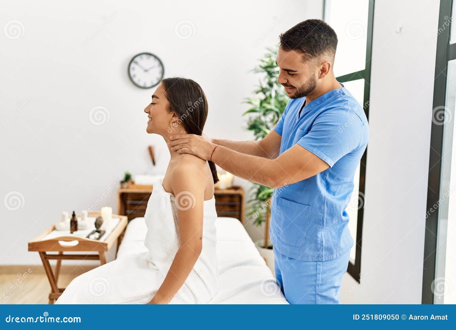 Latin Man And Woman Wearing Physiotherapy Uniform Having Rehab Session Massaging Neck At Beauty