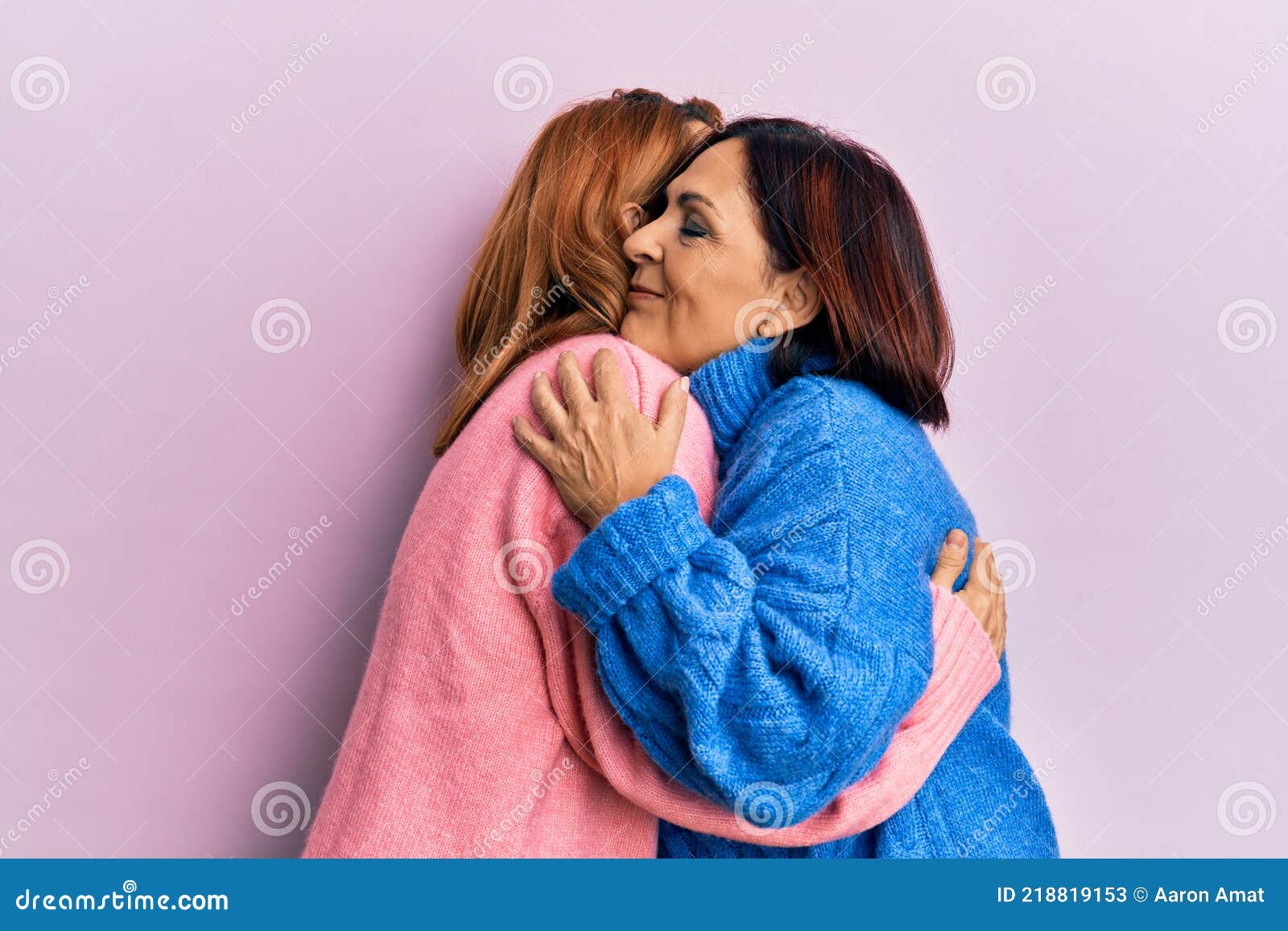 Latin Mother And Daughter Wearing Casual Clothes Hugging Oneself Happy And Positive Smiling