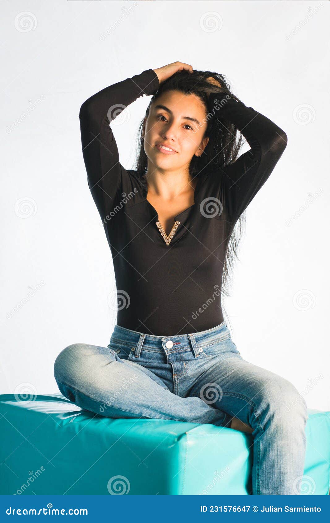 Latin Woman Posing in a Black Blouse. Female Identity: Confident Young  Woman Sitting with Her Hair in Her Hands Stock Image - Image of expression,  identity: 231576647