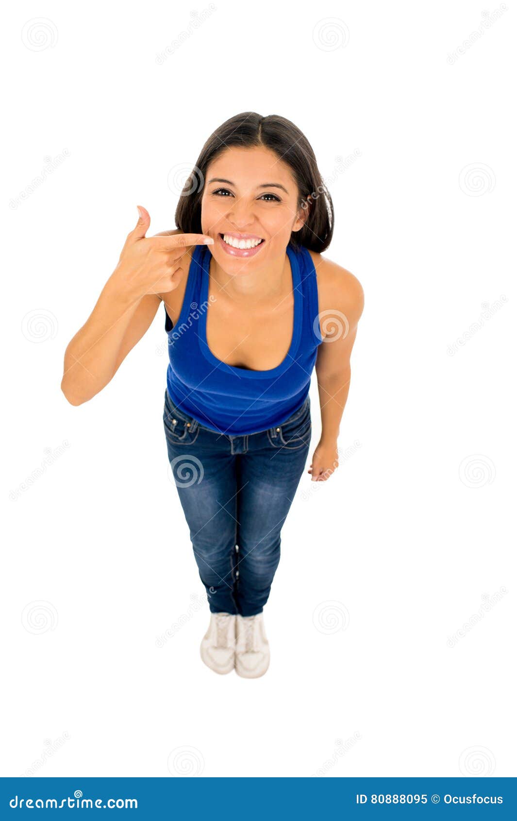 latin woman smiling happy pointing mouth and whiten teeth with her finger in dental care and hygiene