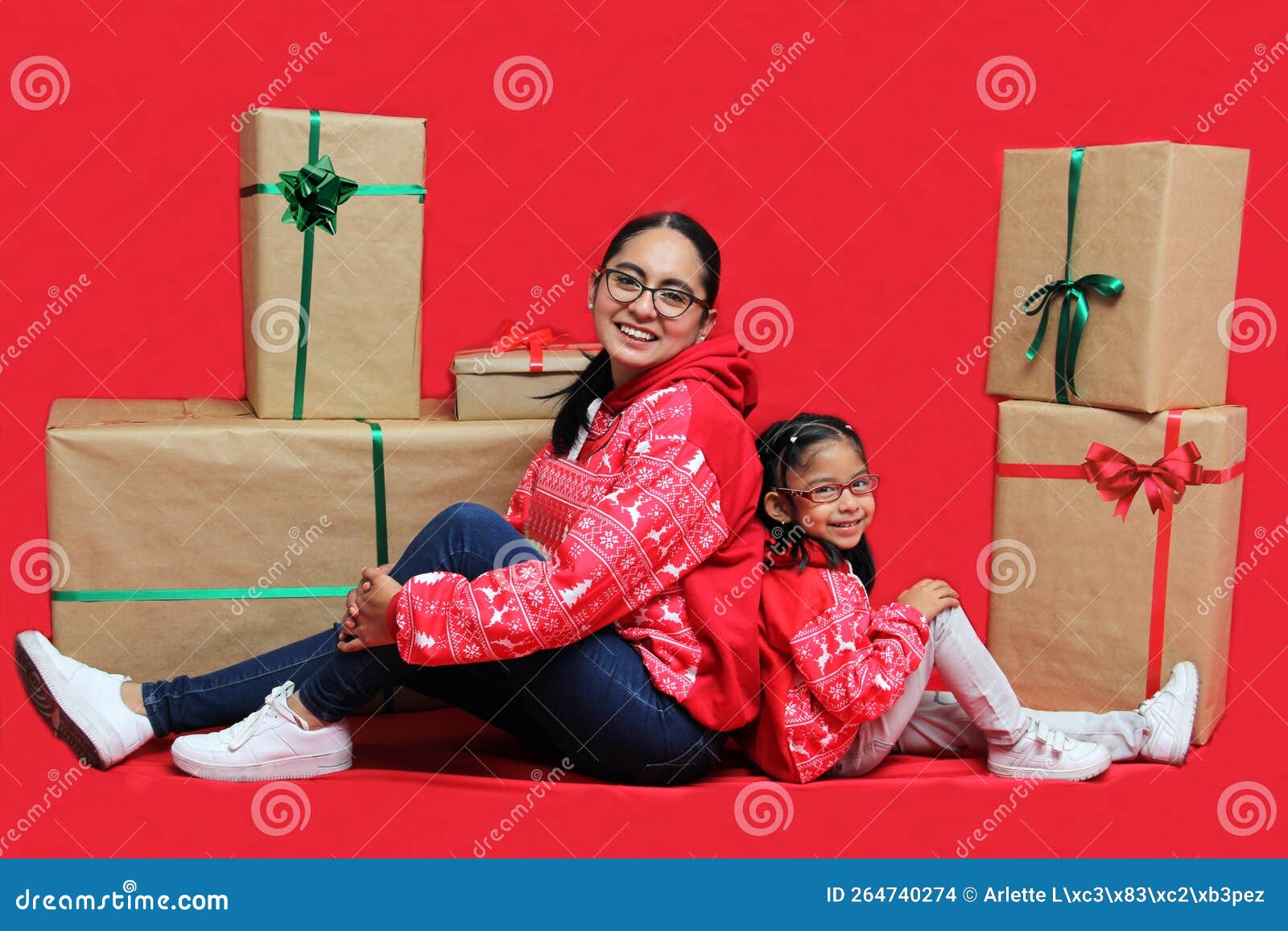 Latina Mom And Daughter With Glasses Wear Ugly Christmas Sweaters And Show Their Love To Each