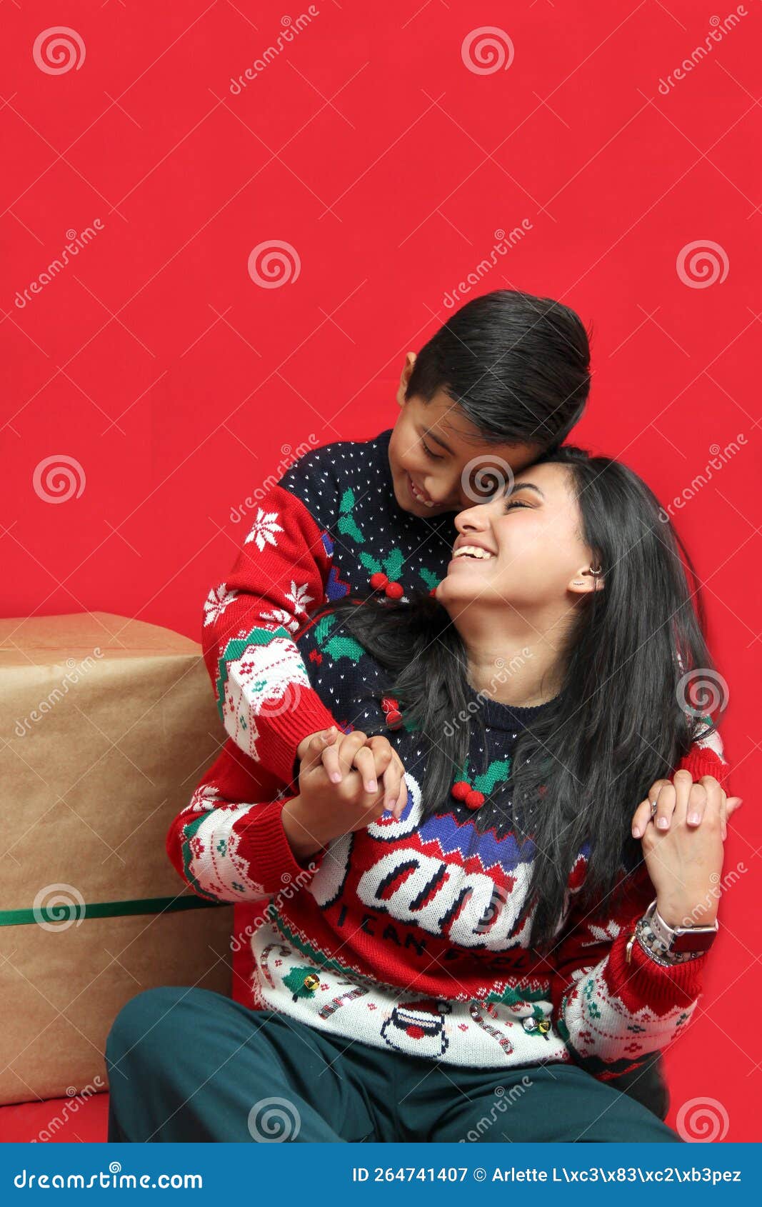 Latina Mom And Son Wear Ugly Christmas Sweaters And Show Their Love To Each Other On A Red